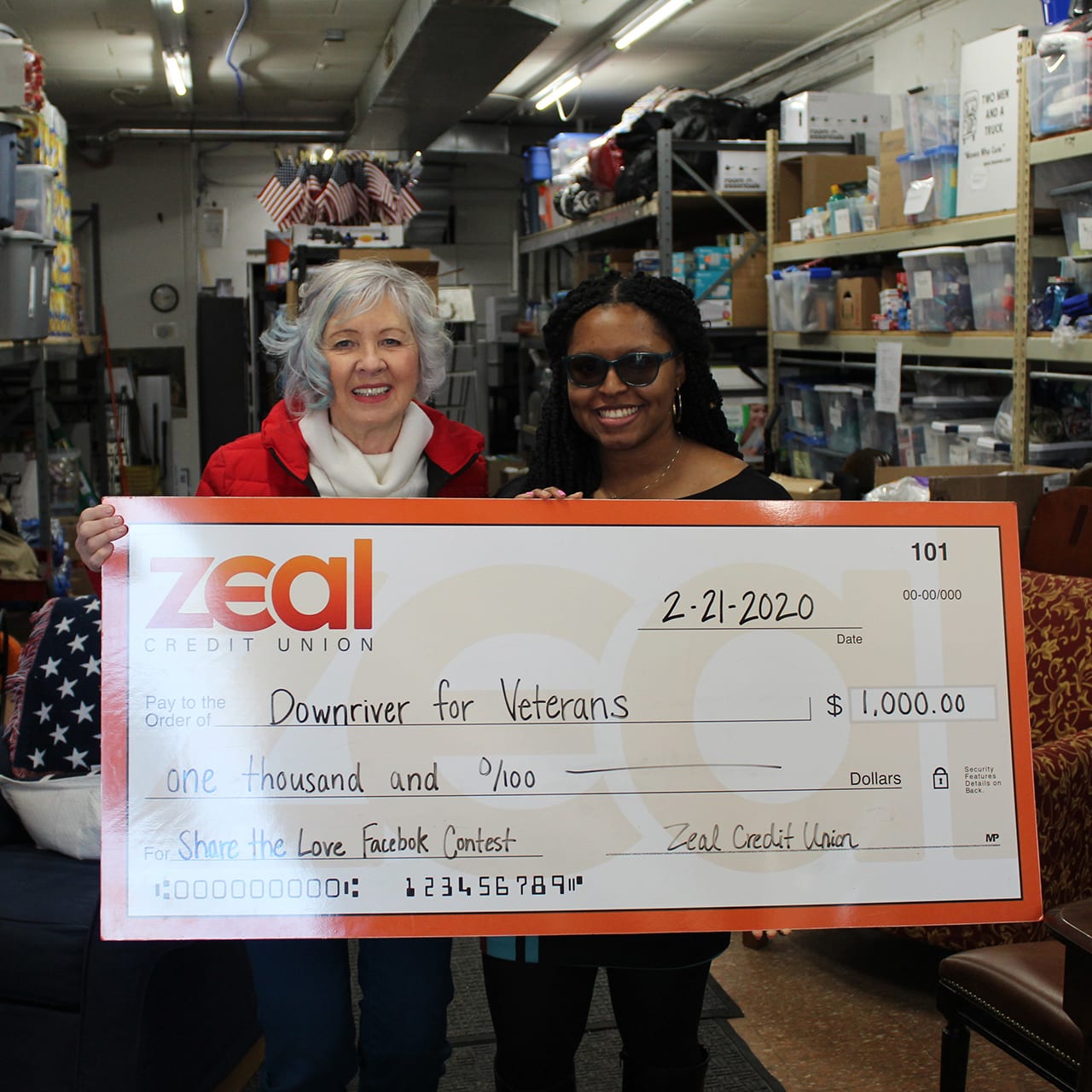 LendingAhelpfulHand(square) zeal employees holding check donation