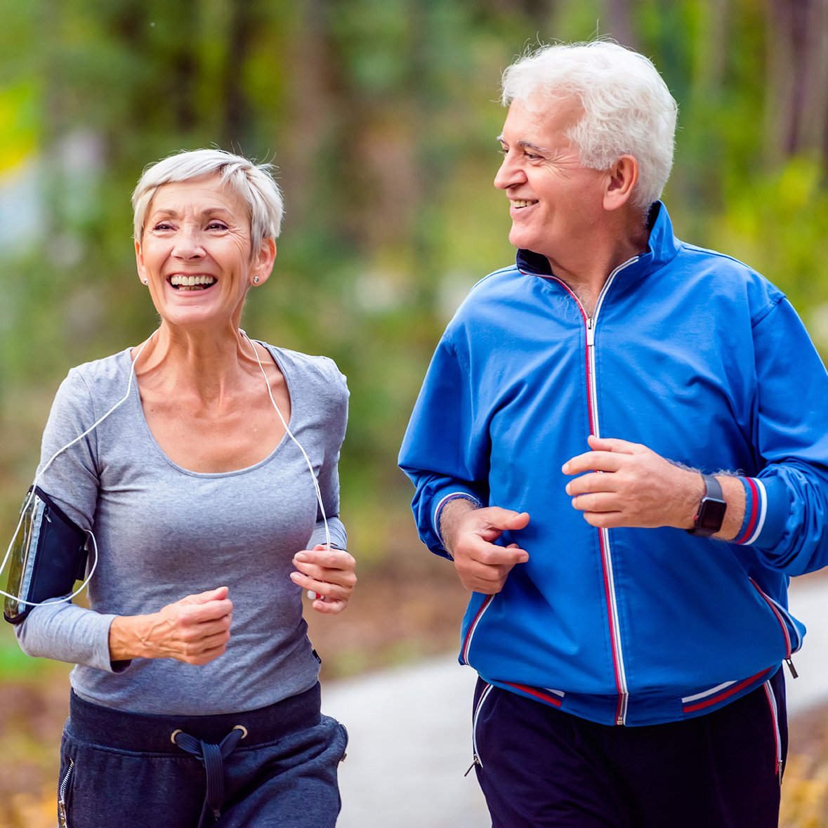 Smiling senior couple jogging in the park