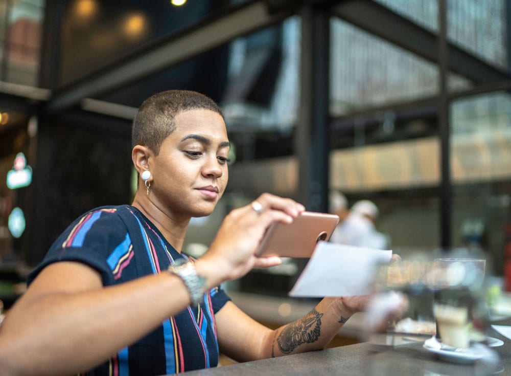 iStock-1155418578 person taking photo of check for bank from phone