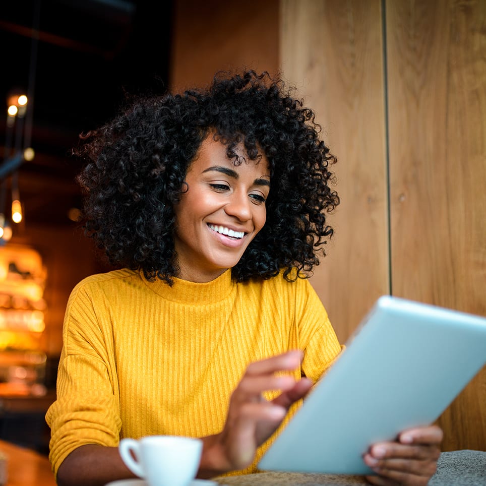 Smiling woman using digital tablet.