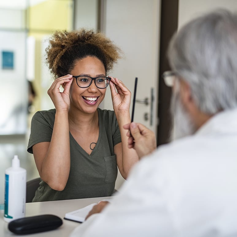 Woman testing out her new eyeglasses in ophthalmology office