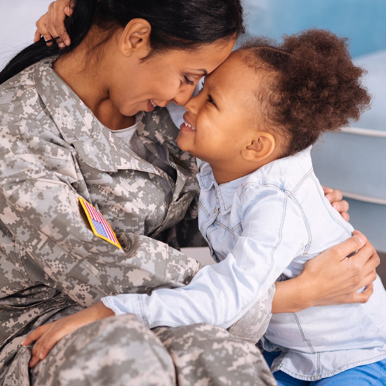 Sweet military loving family cuddling in a living room