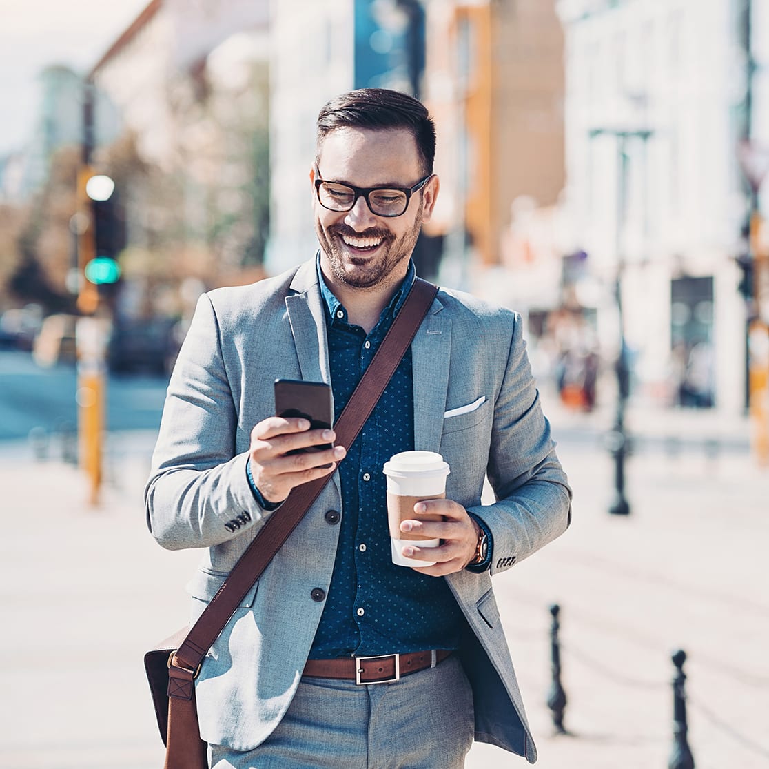 Businessman with a cell phone on the street