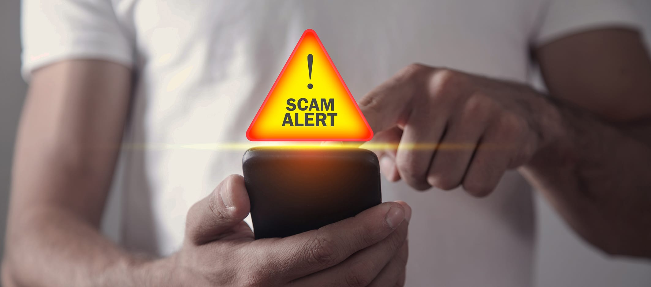 Man holding smartphone. Scam Alert