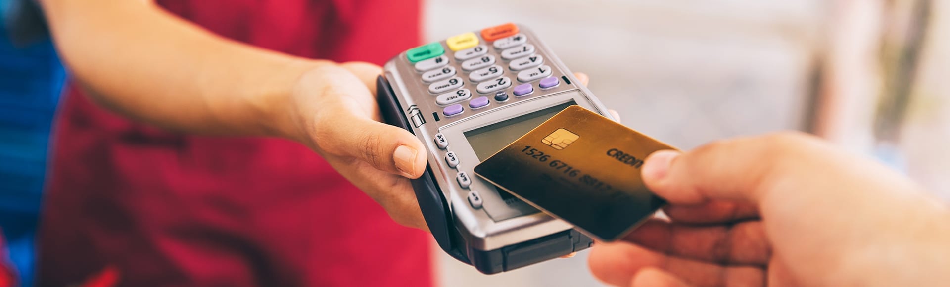 A contactless credit card making a payment with a card reader