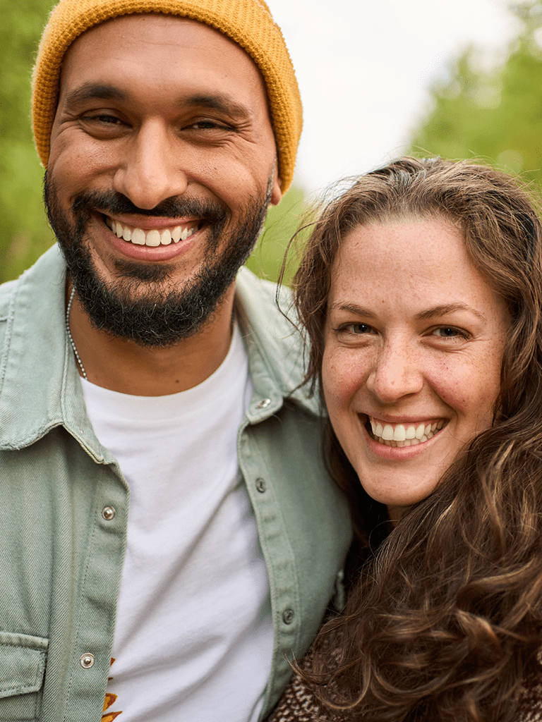 Photo of a smiling woman and man facing the camera