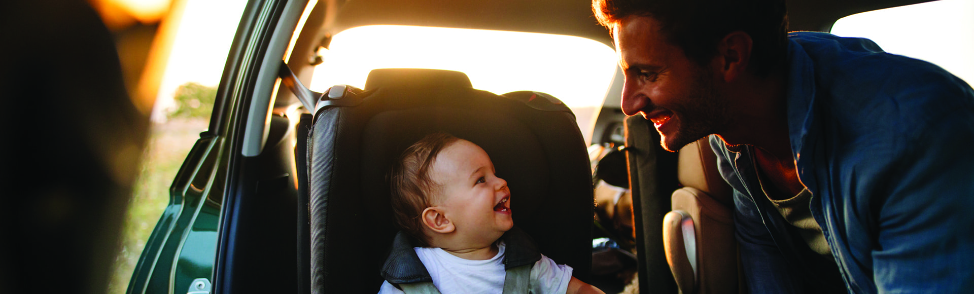 Photo of young father spending time with his son by taking him on a road trip in nature