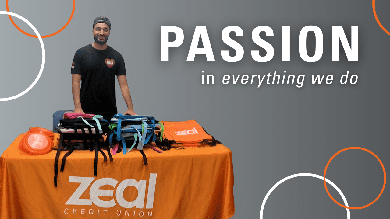 Carousel_Careers_Passion Assistant Branch Manager smiling with a table full of youth giveaways, including backpacks and frisbees for Back to School. Caption reads "PASSION in everything we do."