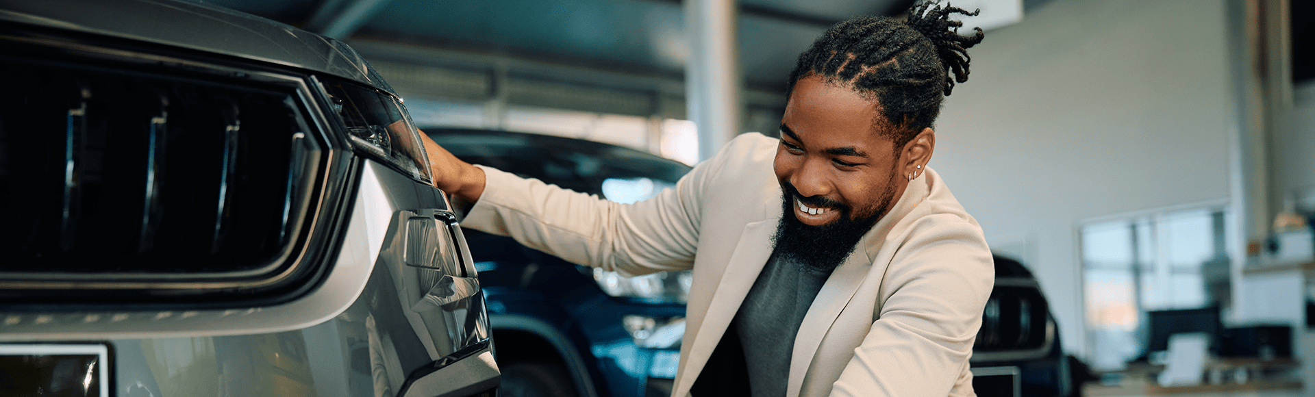Adult man admiring new vehicle at auto show
